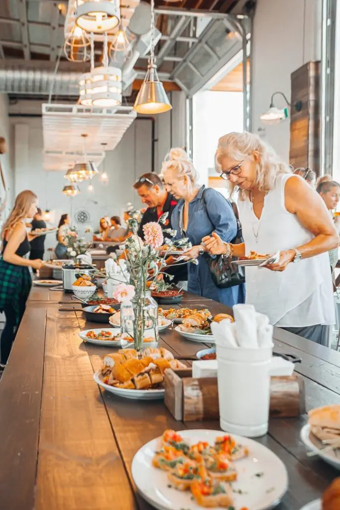 Guests at a buffet in a bright taproom in downtown Kelowna