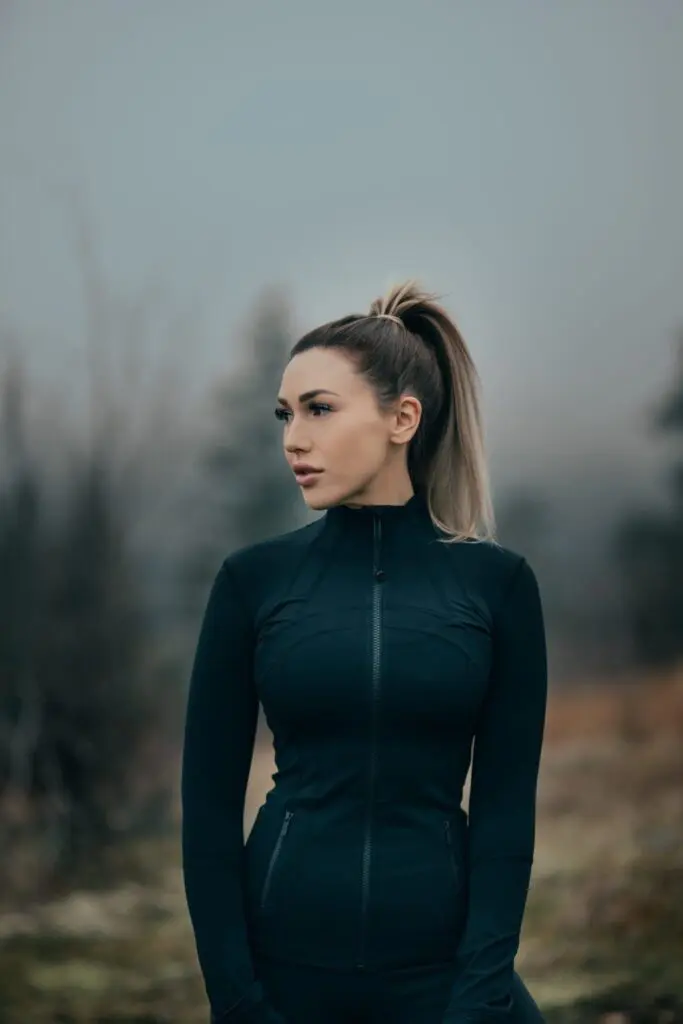 Outdoor portrait of a woman in a dark jacket in soft fog near Kelowna