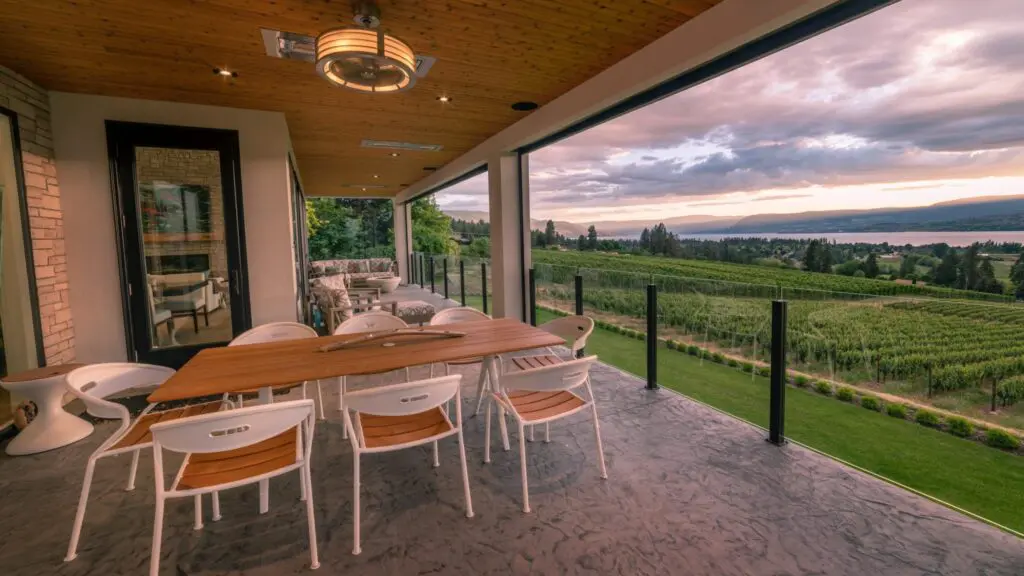 Covered patio of a home overlooking a vineyard and the lake