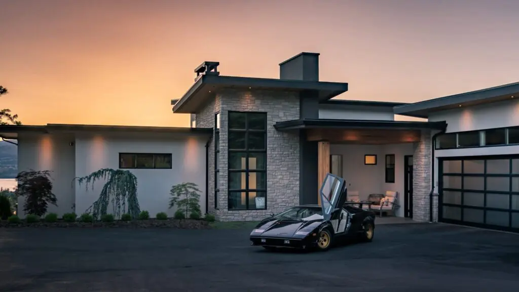 Modern home exterior at dusk with the lights on