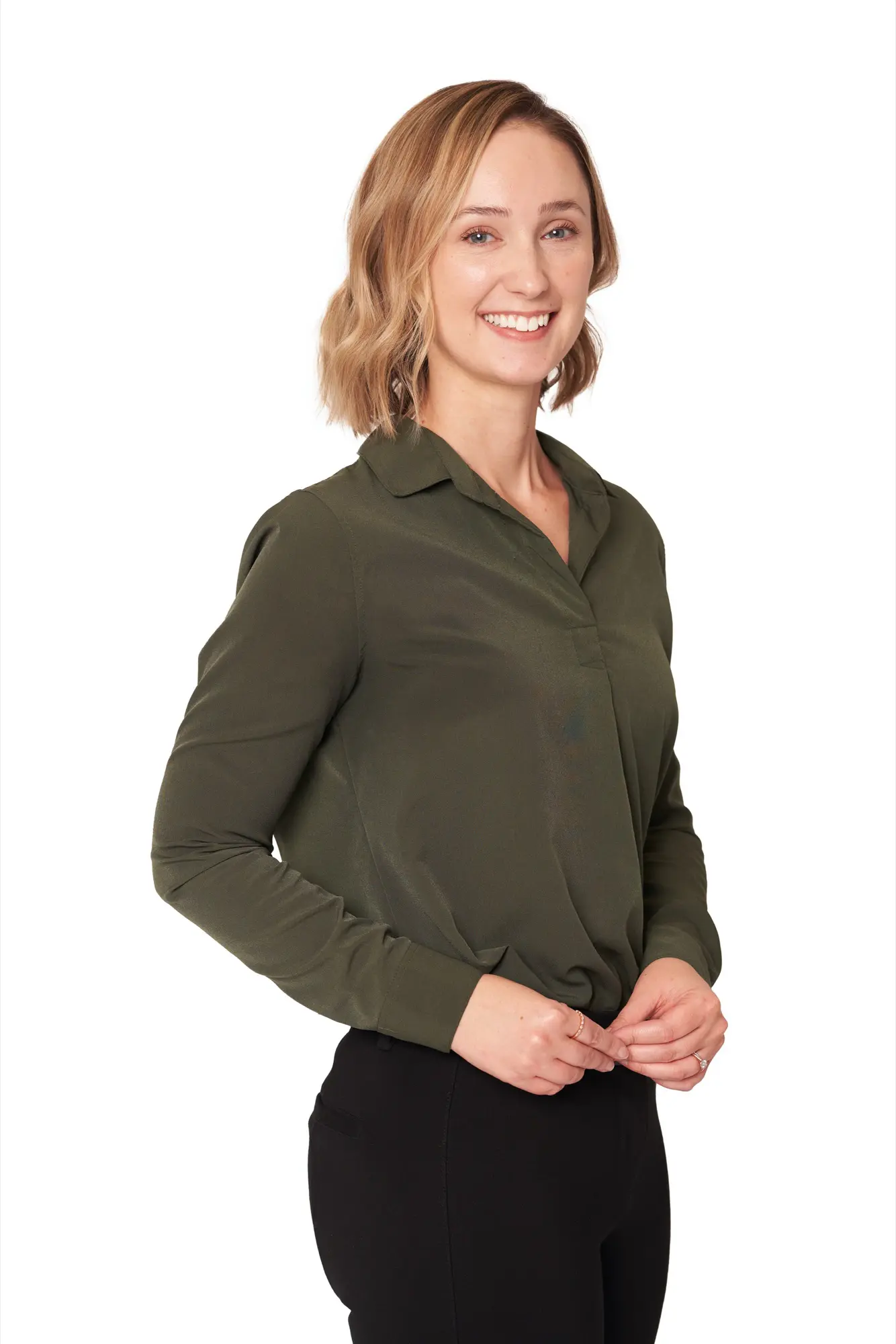 Smiling woman in an olive blouse in a LinkedIn headshot on a white studio background in Kelowna